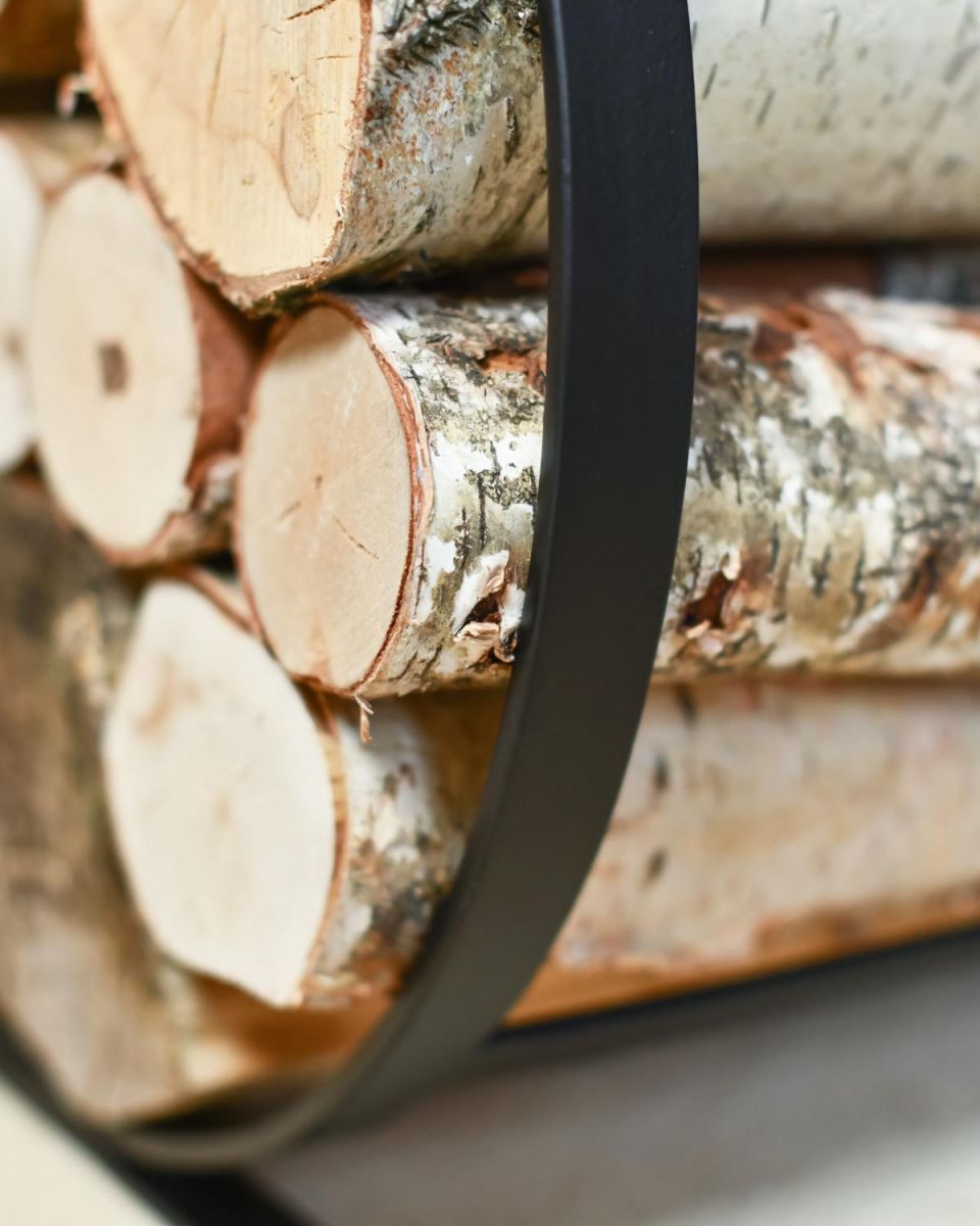 Close Up Of Black Blacksmith Curved Log Rack In Situ