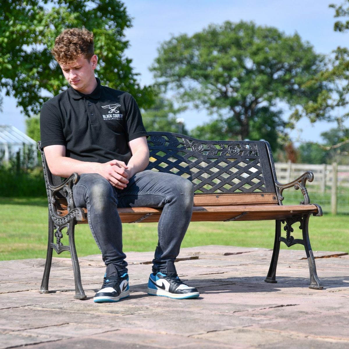 Aged Black Cast Iron & Wood Garden Bench with Male for Scale