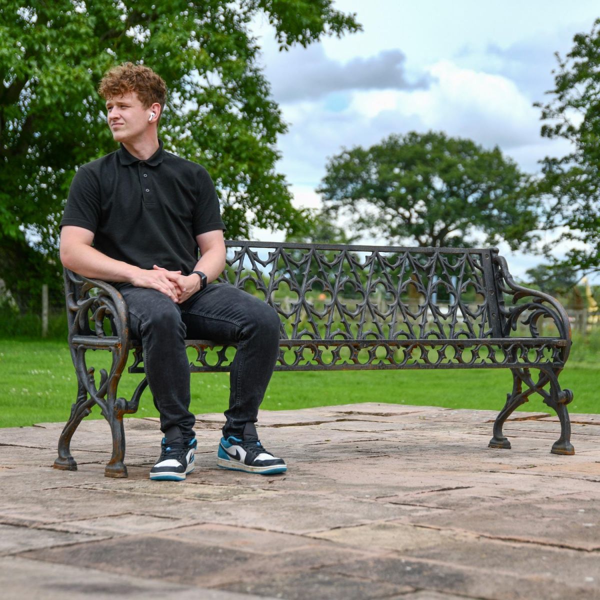 Cast Iron "Quatrefoil" three seater bench with male for scale 