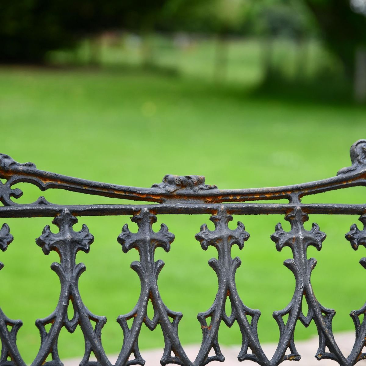 Close up of Aged Black Cast Iron Gothic Backrest Design