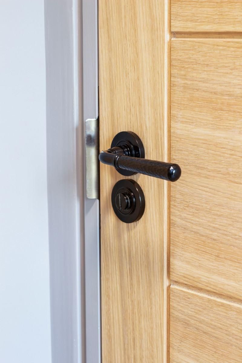 Black Hammered Lever Door Handle on Rose in Situ