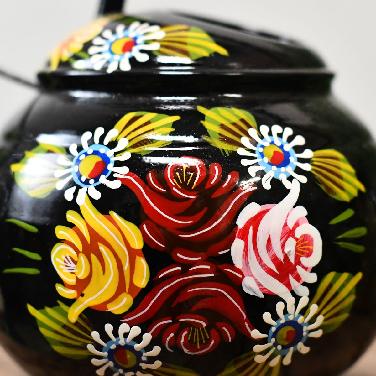 Close-up of the Floral Design on the Black Watering Can