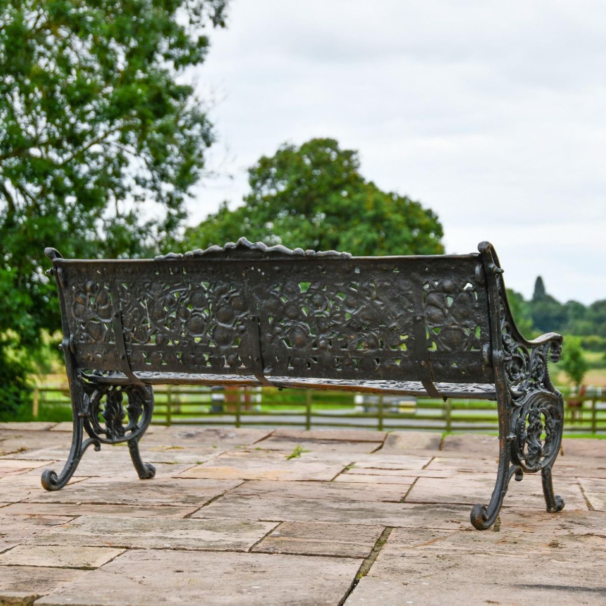 Rear view of Cast Iron Aged Black Garden Bench in Situ