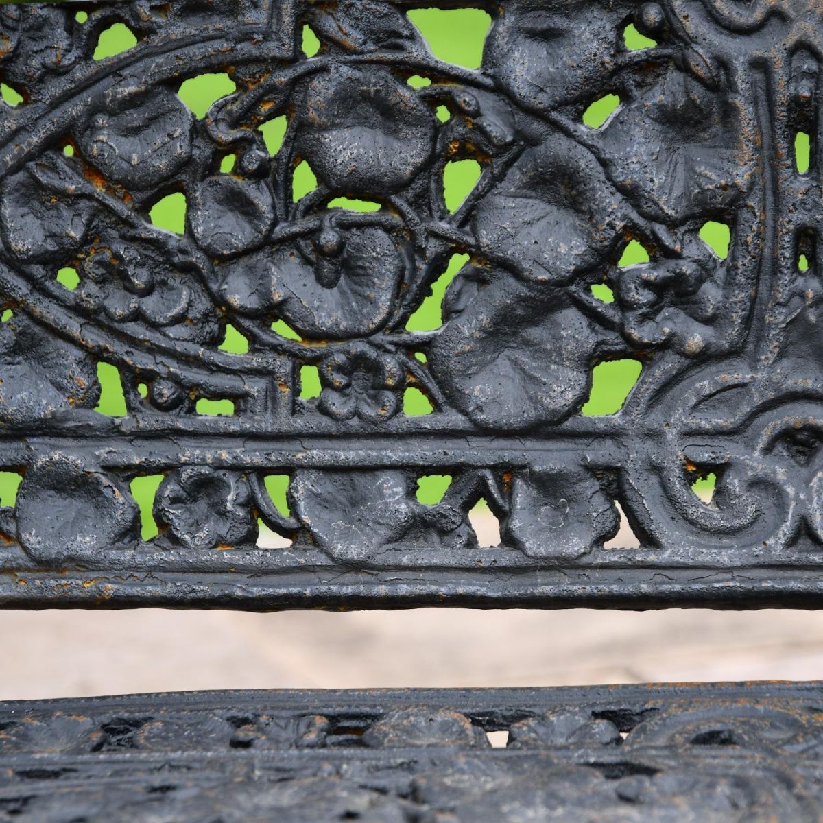 Close up of leaf design on Aged Black Cast Iron Bench