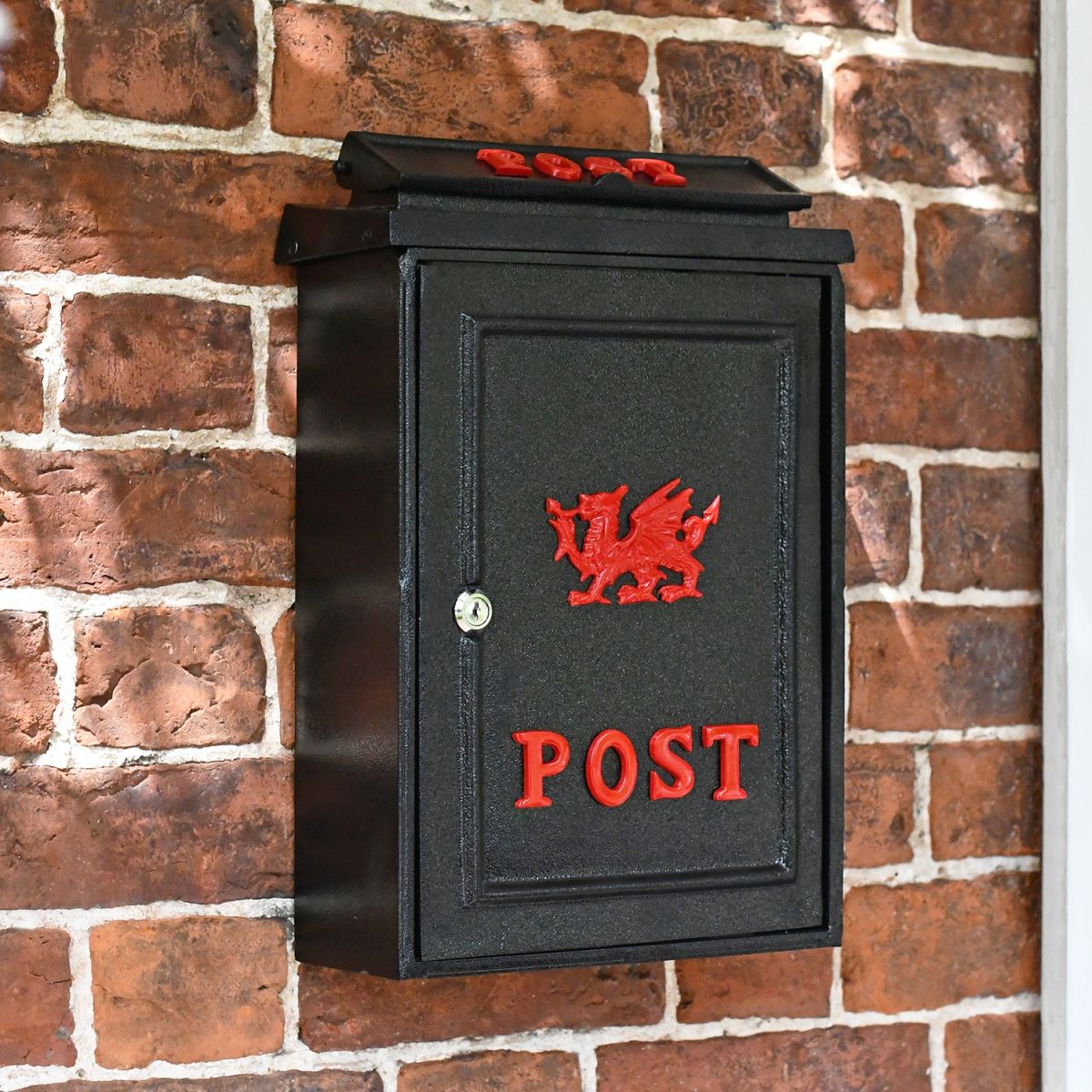 Black Post Box With Red Lettering and a Red Welsh Dragon 