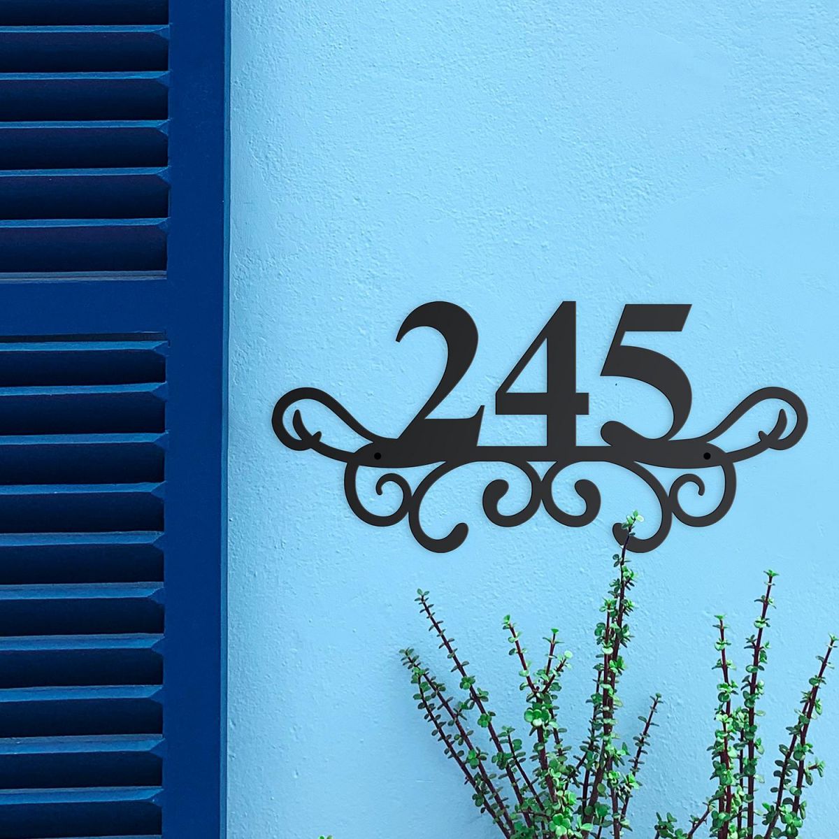 Traditional Iron Ornate Number Sign on a Blue Wall