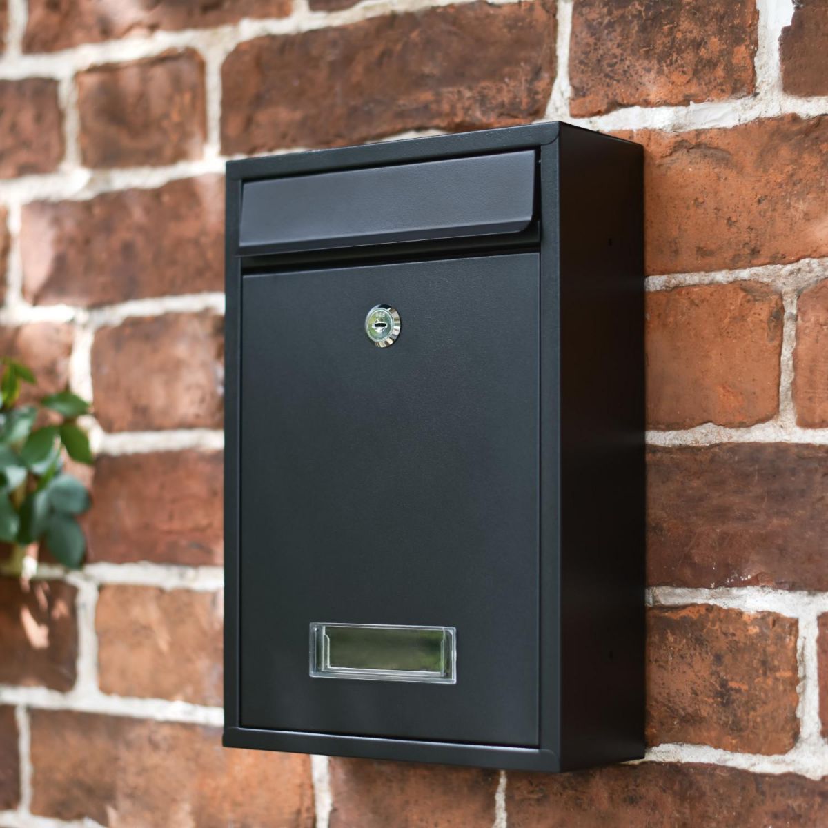 Slim Black Lockable Wall Mounted Post Box in Situ on a Brick Wall