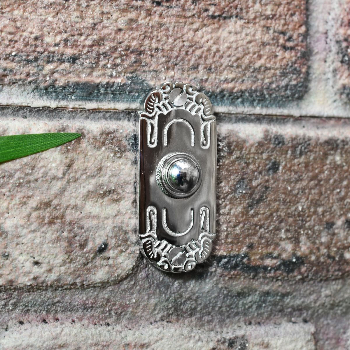 Bright chrome door push button with art nouveau style engraving