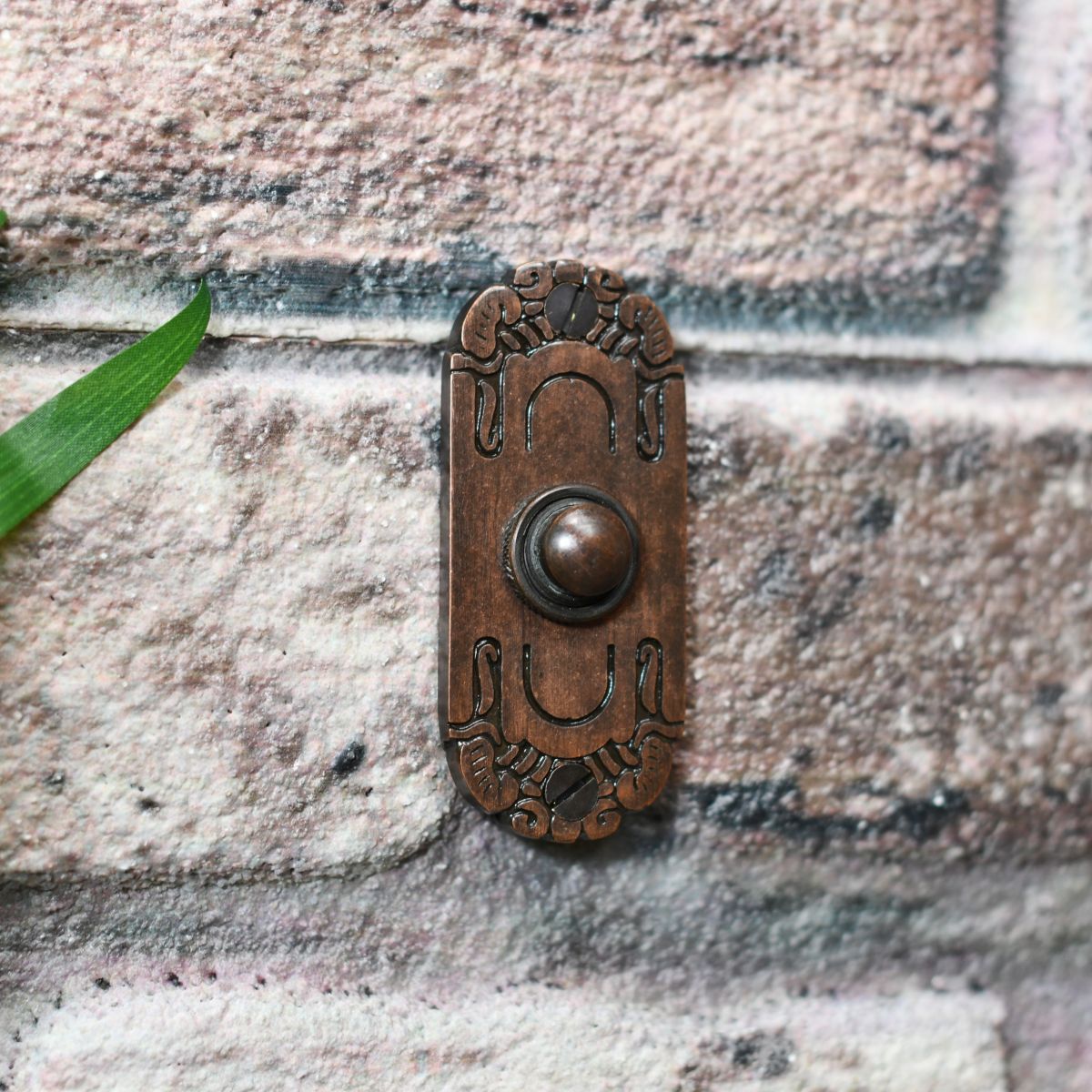 Ornate door bell finished in burnished copper