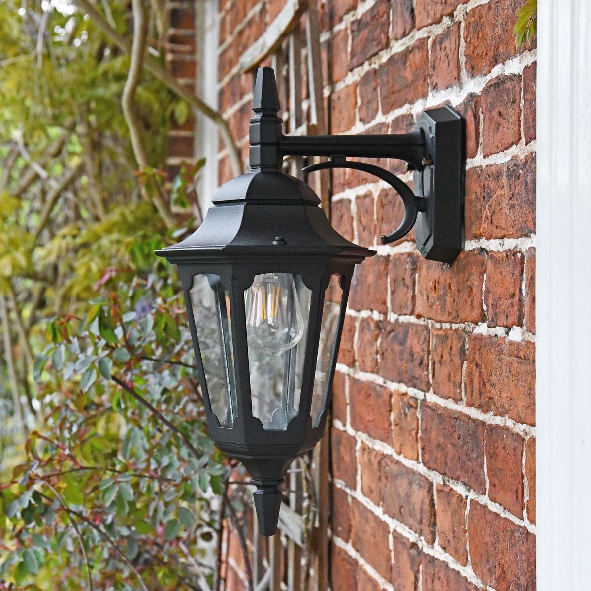 Bridlington Large Top Fix Black Wall Lantern in Situ on a Brick Wall
