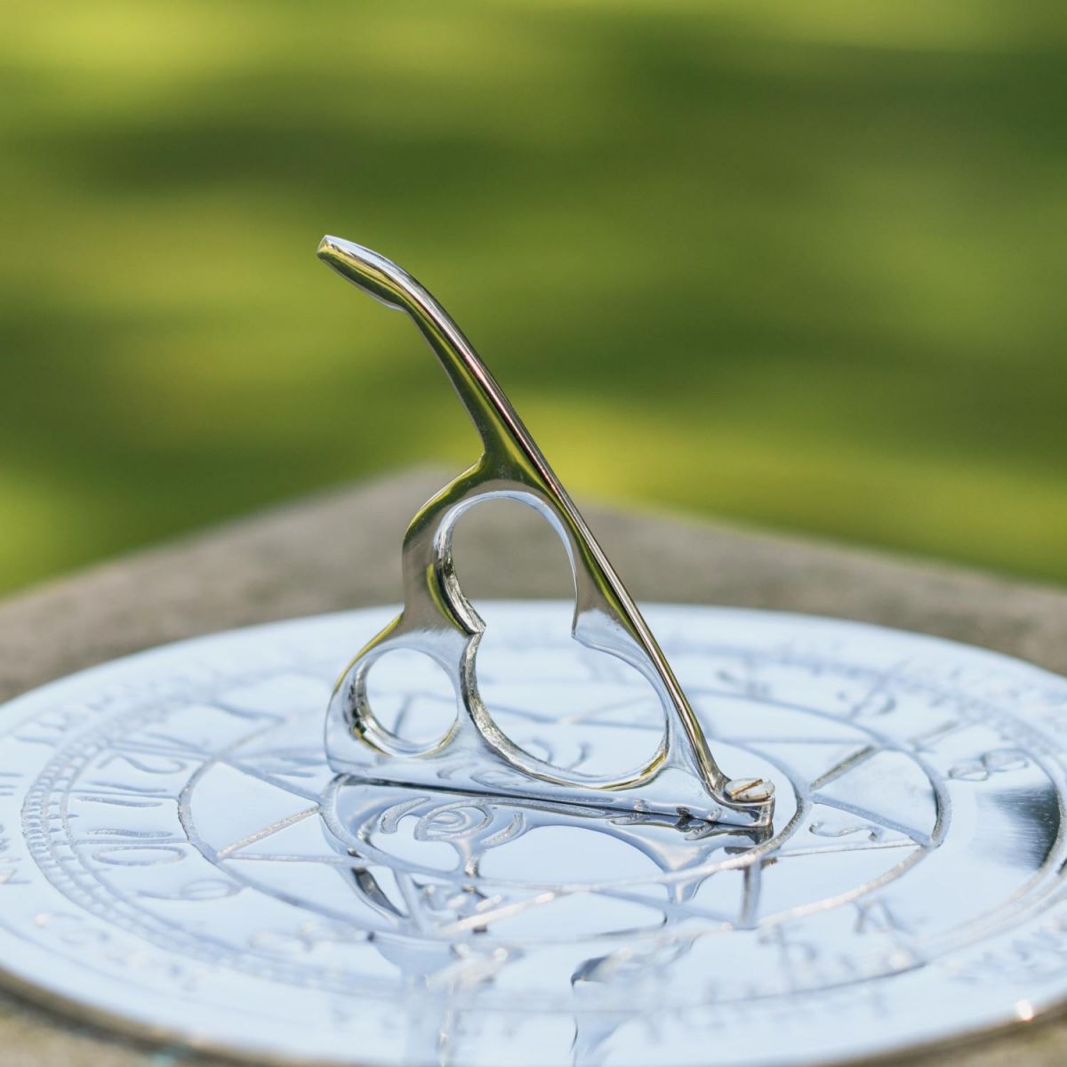 Close-Up of Sundial Gnomon on Bright Chrome Compass Point Sundial- 180mm 