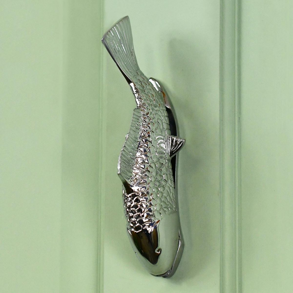 Bright Chrome Fish Door Knocker On Green Door