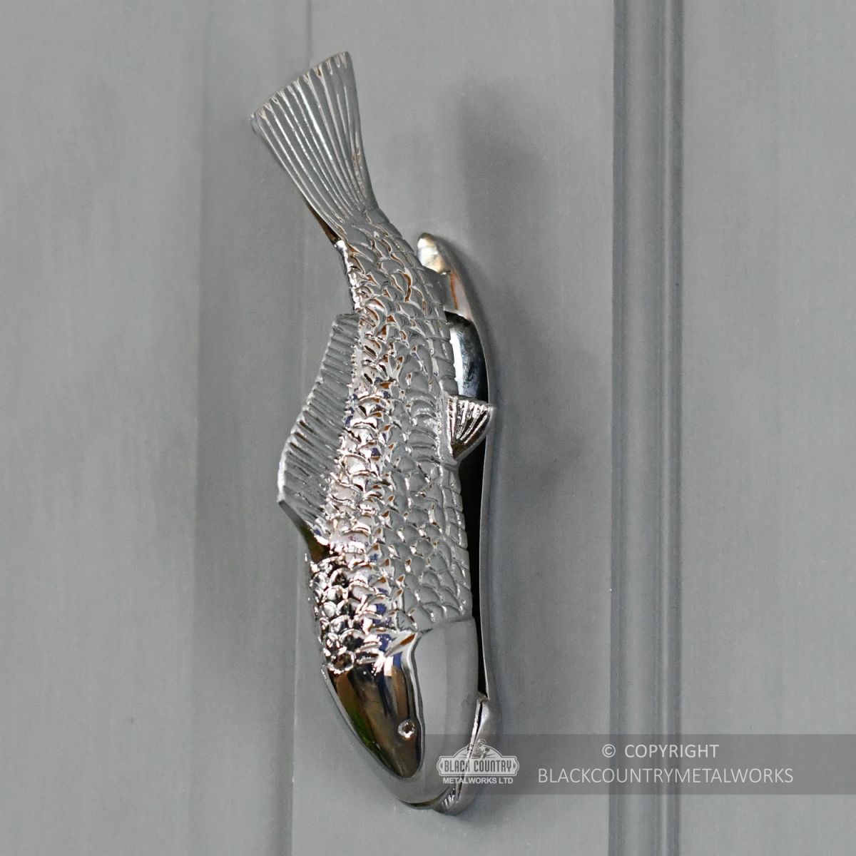 Bright Chrome Fish Door Knocker On Grey Door