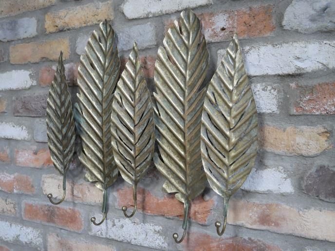 Brushed Gold Leaf-Shaped Hook Rack on Brick Wall