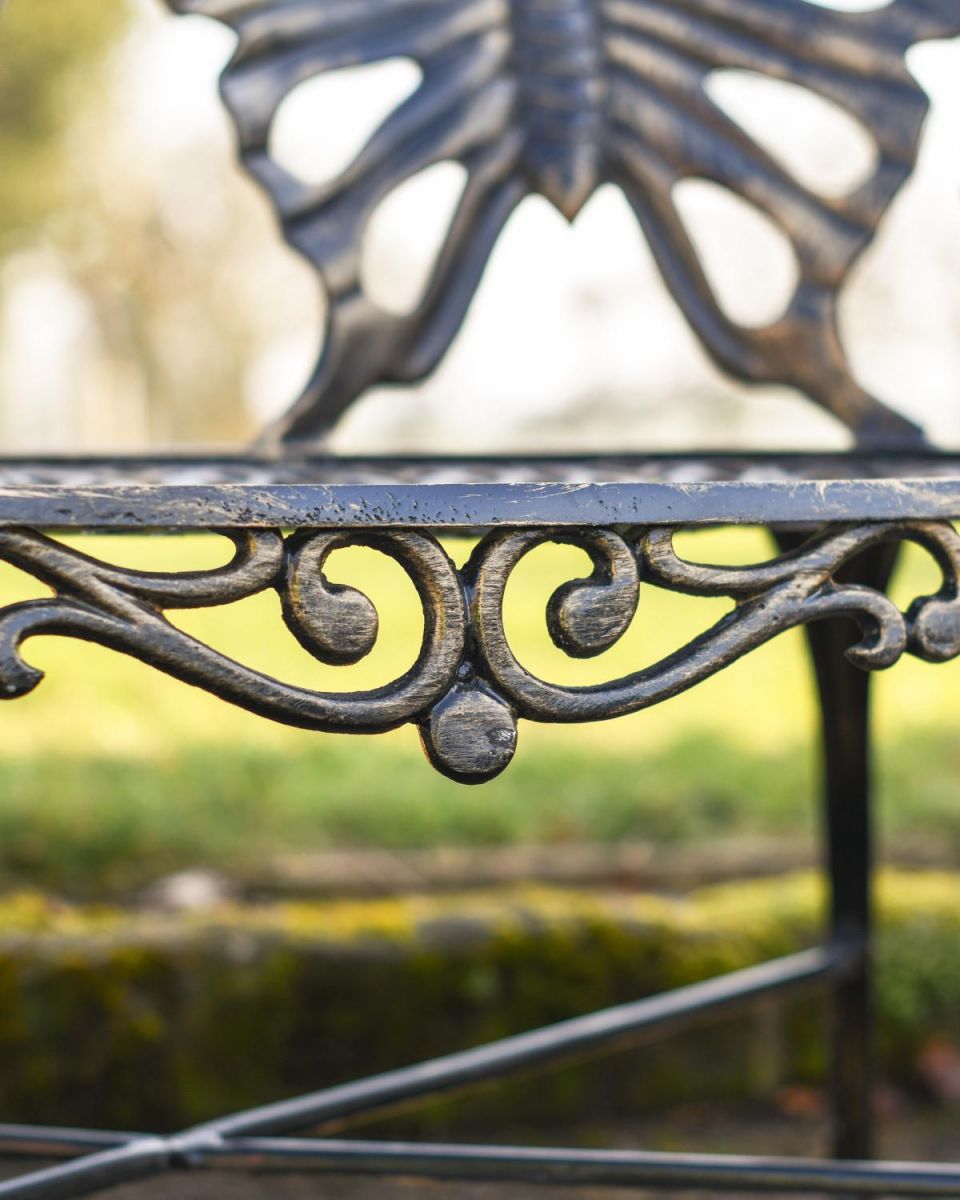 Close Up Of Butterfly Design Two Seater Bench Scrollwork