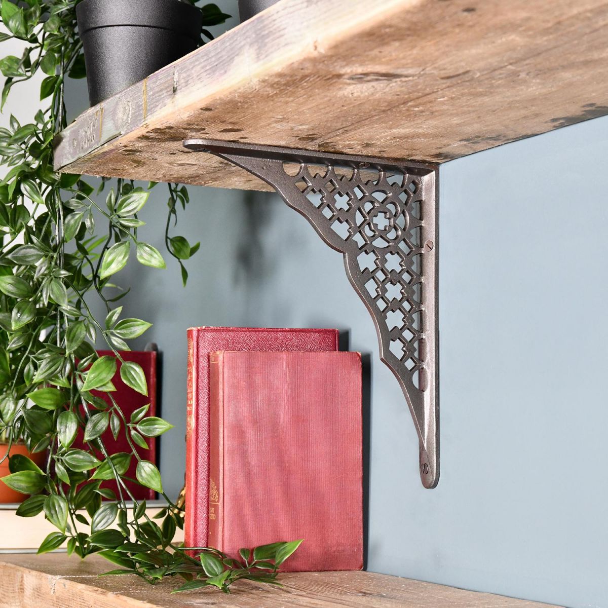 Cast Iron Trellis Patterned Shelf Bracket Holding up a Wooden Shelf