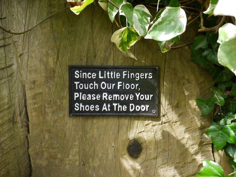 "Remove Your Shoes" Cast Iron Wall Sign in Situ
