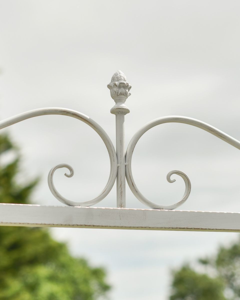 Close up of ornate scrollwork detail on champagne swing seat 
