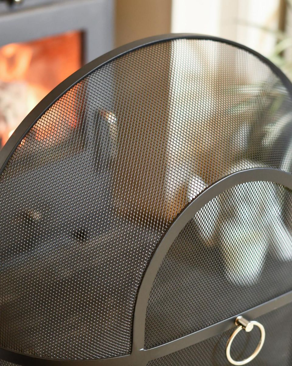 Close Up Of Classic Black Arched Fire Guard with Circular Handle In Situ