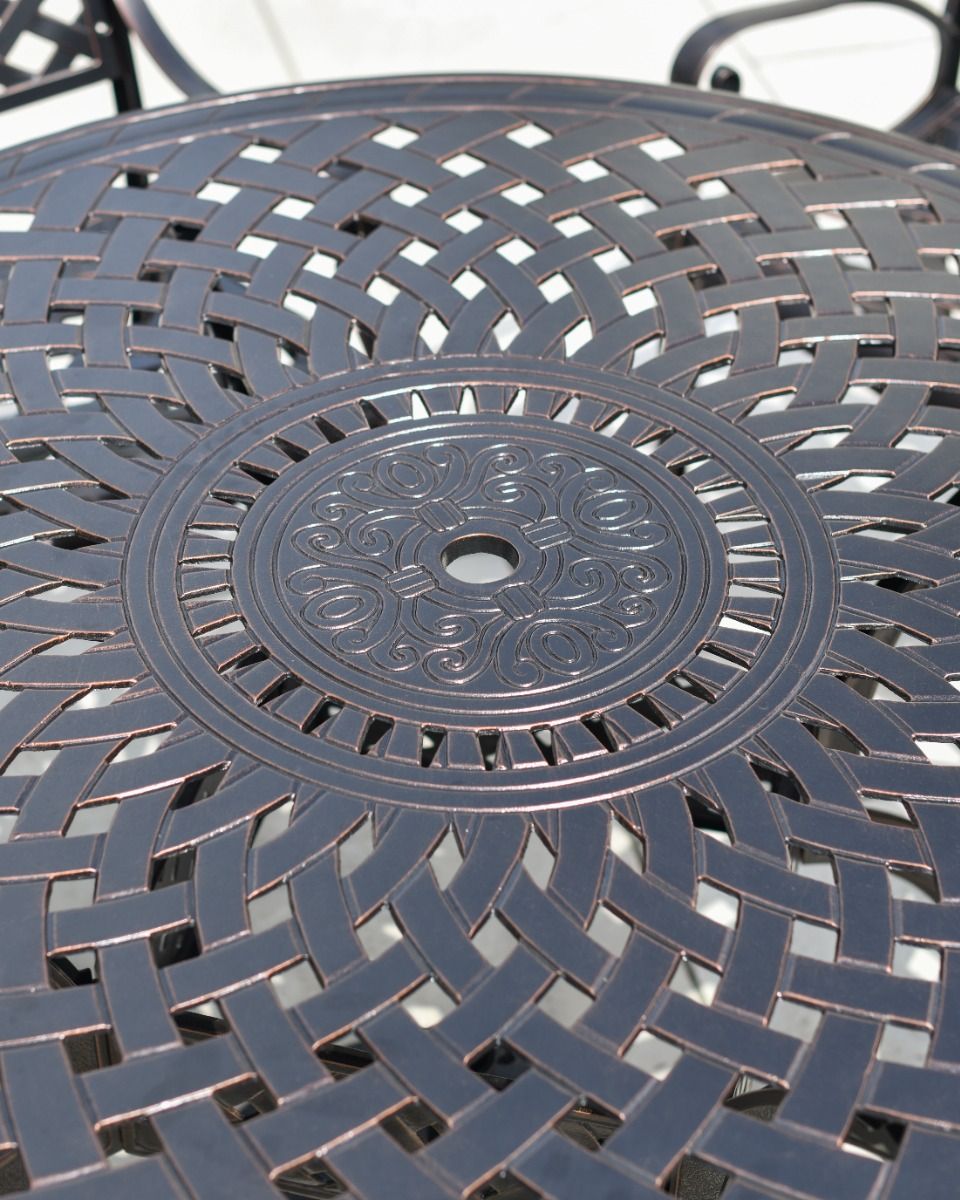 Close up of the lattice and ornate pattern on the table.