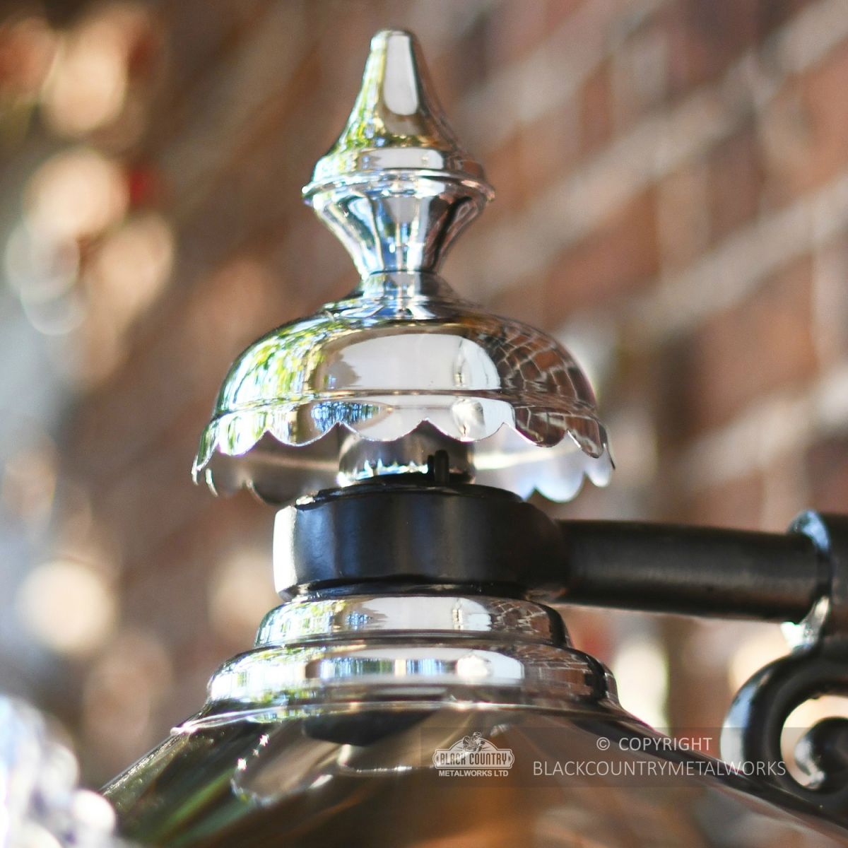 Close-up of the Top Fixing On The Bright Chrome Wall Lantern