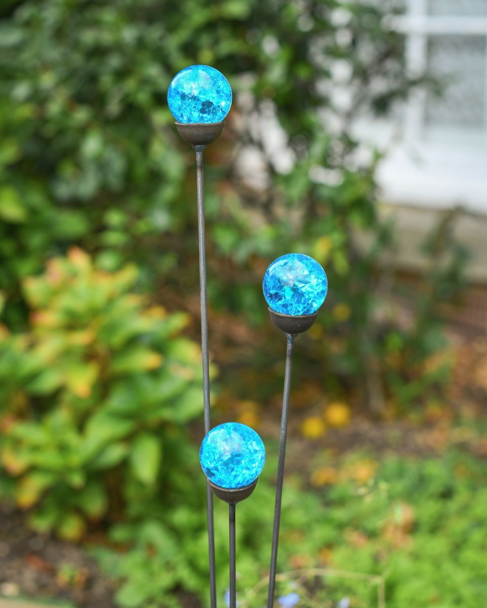 Close up of blue suncatcher plant pot stakes