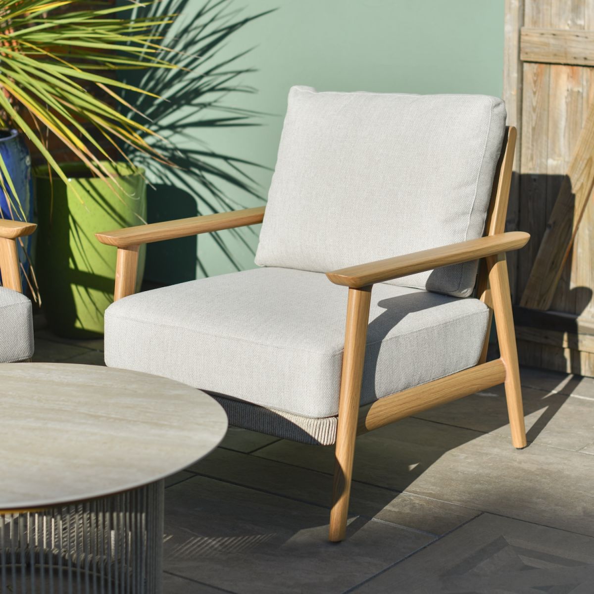 Close up of individual armchair with woven rope detailing outdoor lounge set Close up of individual armchair with woven rope detailing outdoor lounge set