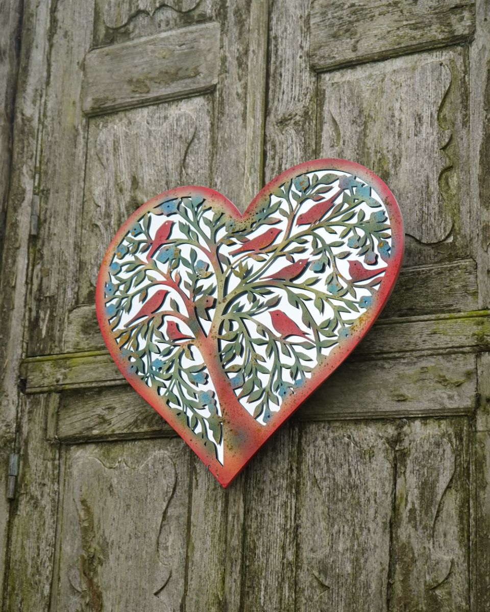 Angled view of intricate rustic finish steel detail garden wall art