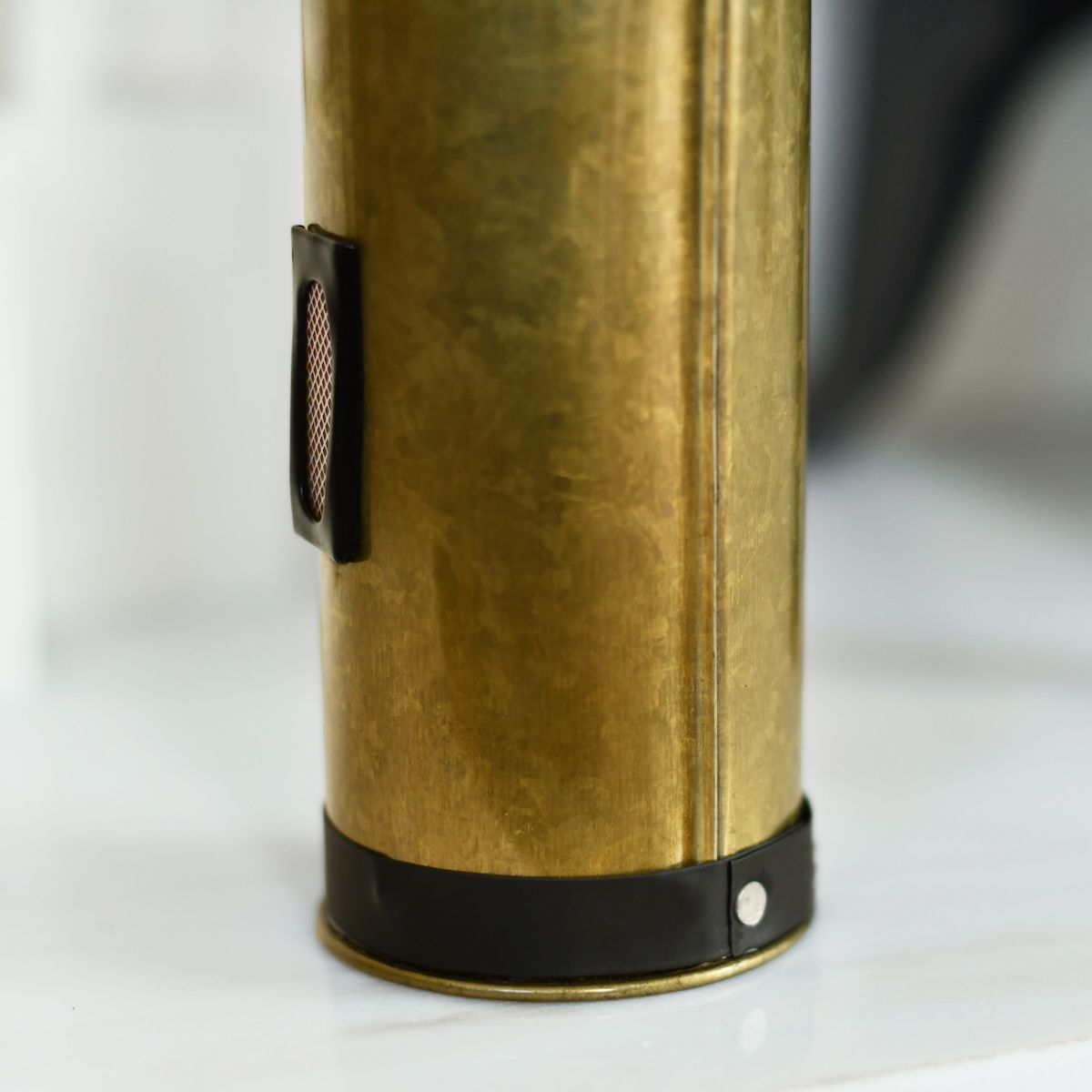 Close up of base and striker strip on bronze match holder