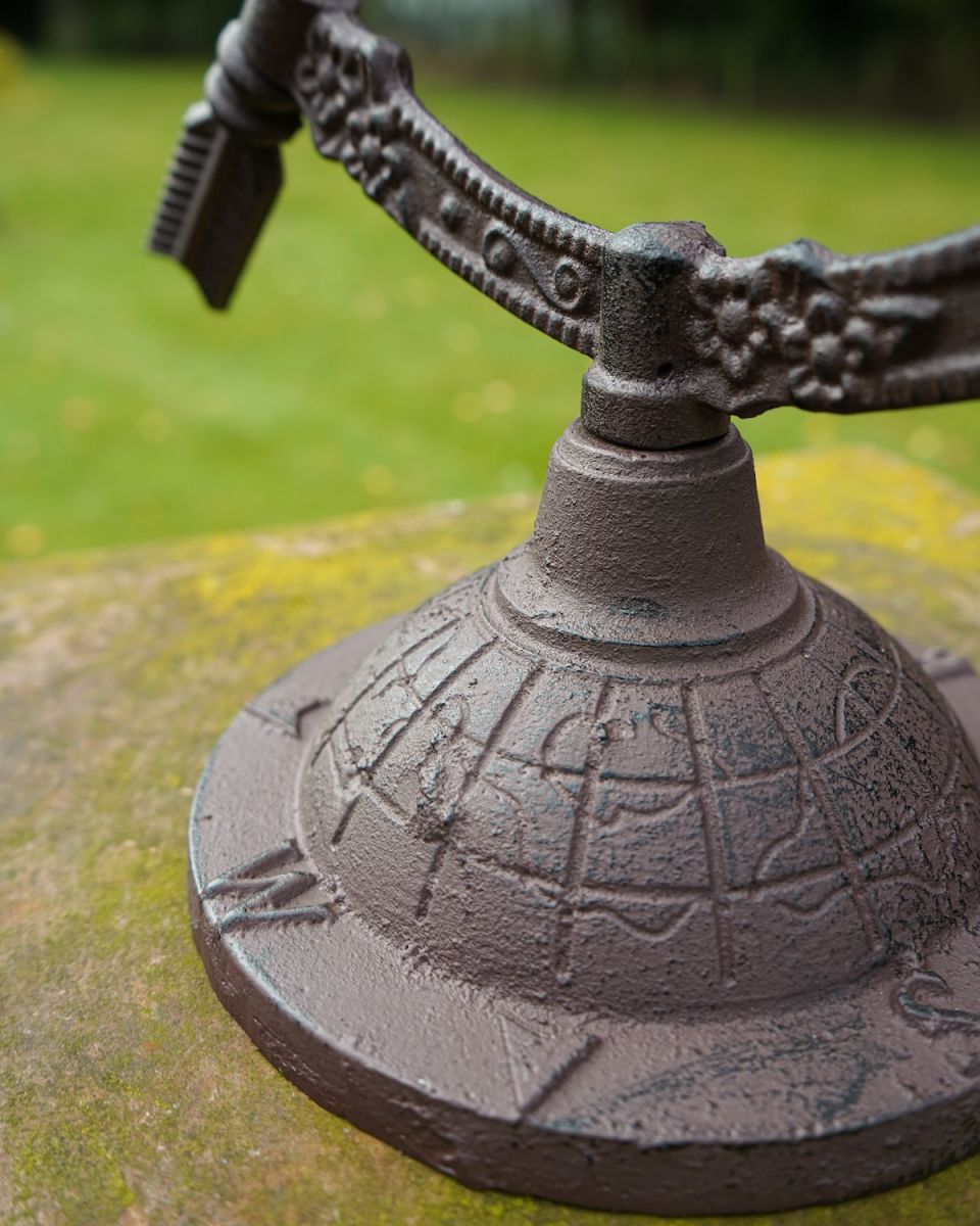 Close up of freestanding globe base on Rustic Metal Altair Armillary