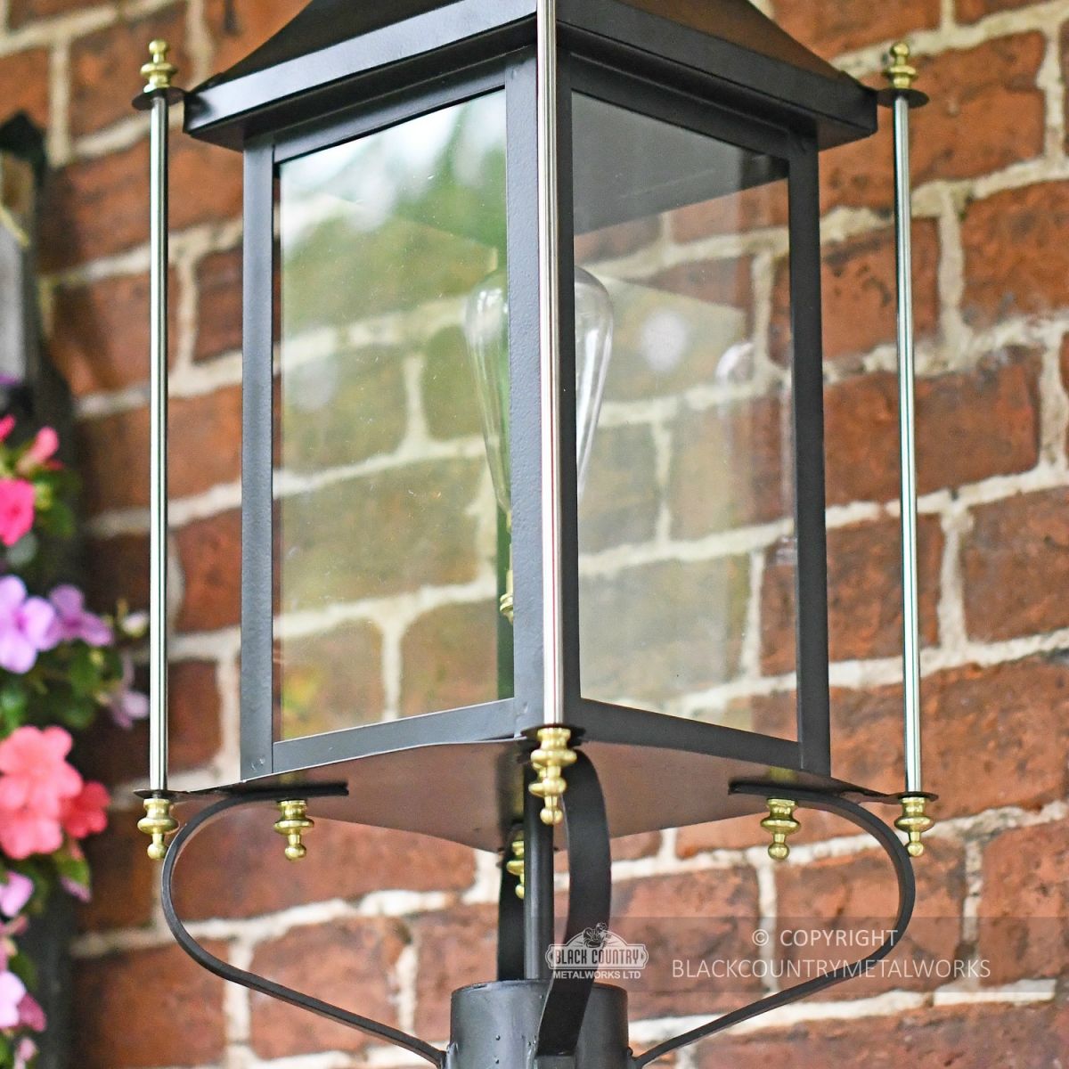 Close Up Of Black Victorian Wall Light With Brass Bar Decoration