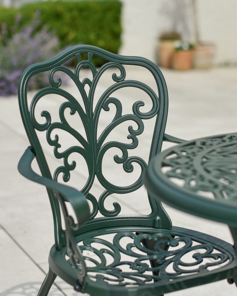 Close up of ornate chair backrest detail on patio table and chairs set