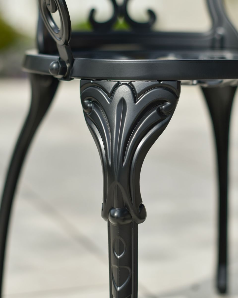 Close up of ornate chair leg detail on two seater garden table and chairs set