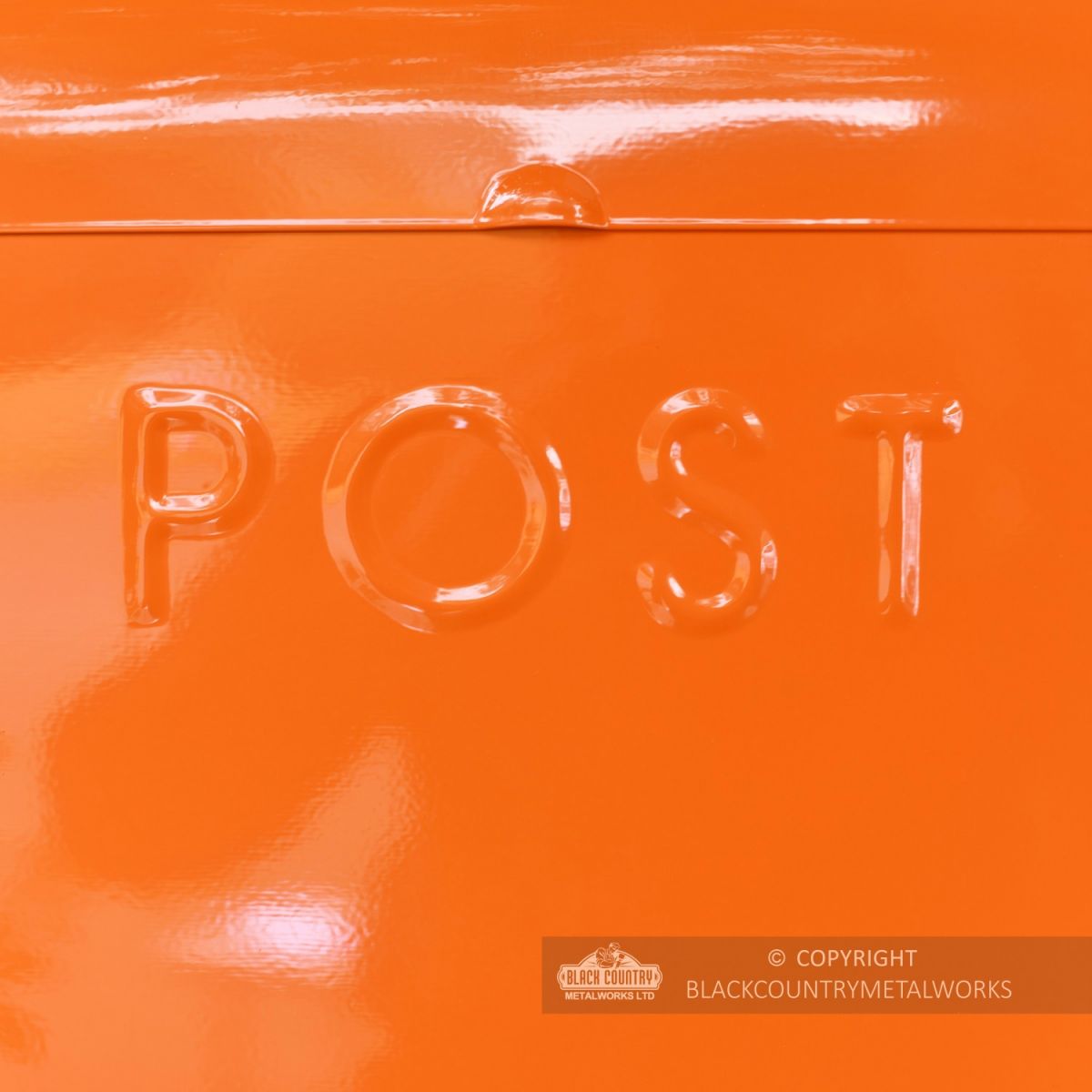 Close Up Of Embossed Lettering On Orange Post Box