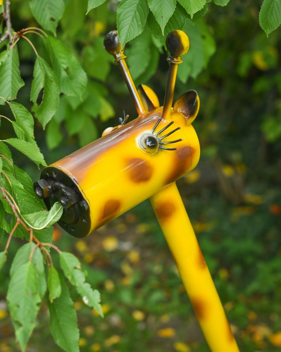 Close up of intricate face detail on giraffe outdoor sculpture
