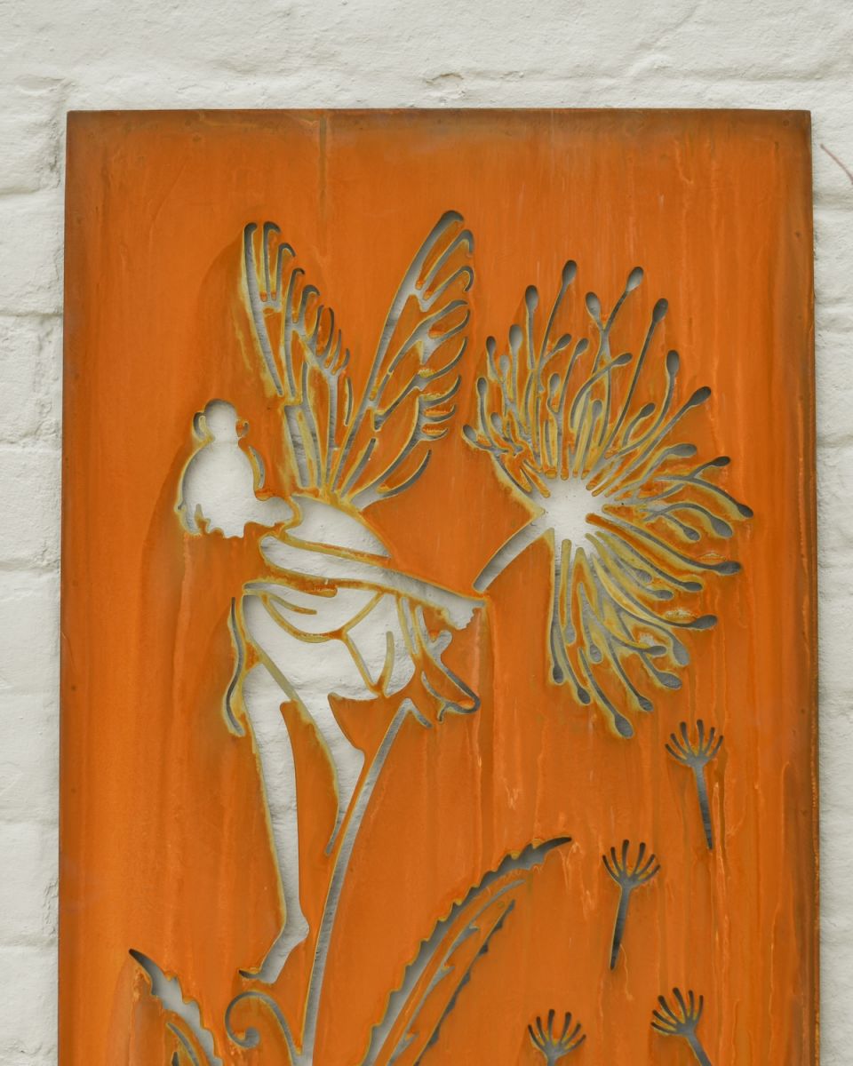 Close up of intricate cut out fairy detail on rustic garden wall art