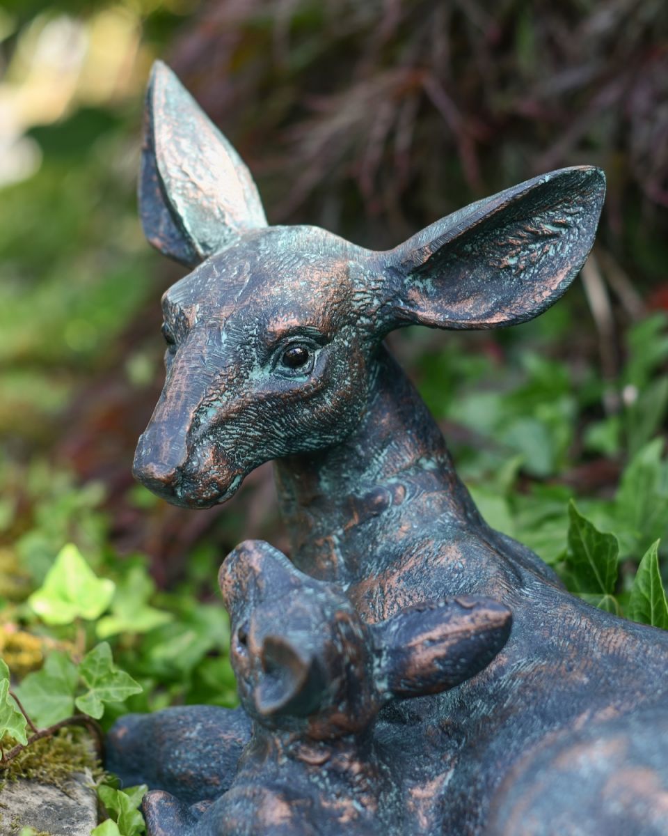 Close up of fawn detail on verdigris garden sculpture