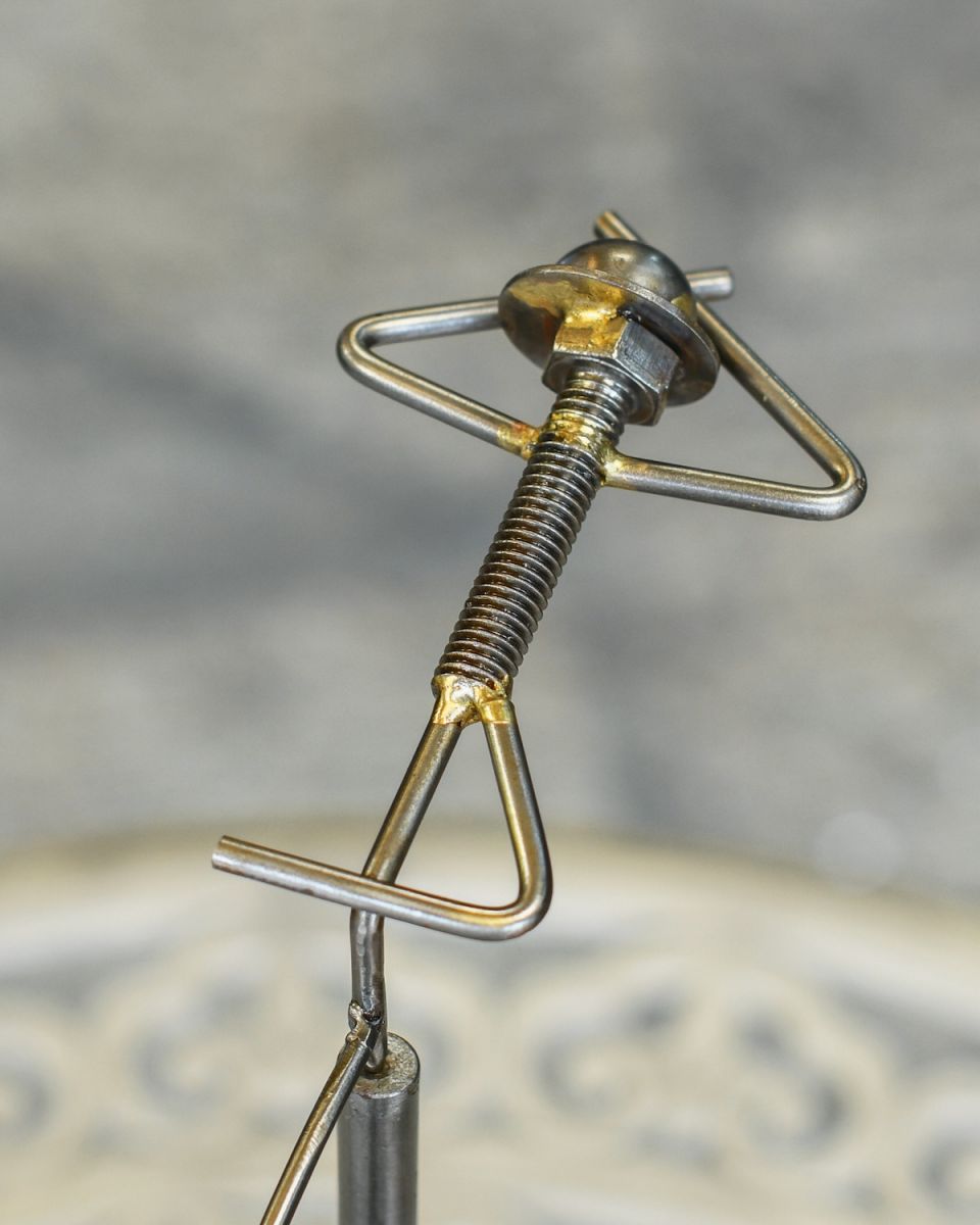 Close up of reclining figure on scrap metal art sculpture
