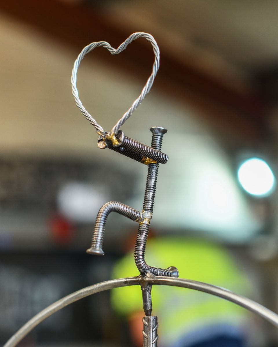Close up of heart detailing on scrap metal art sculpture