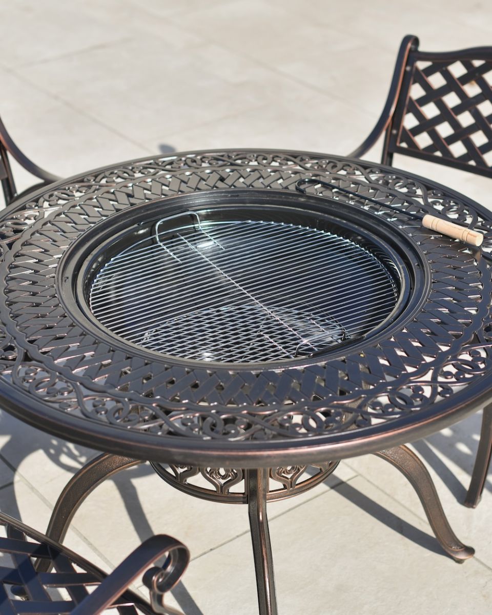 detailed close up of dining table with firepit bbq centre 