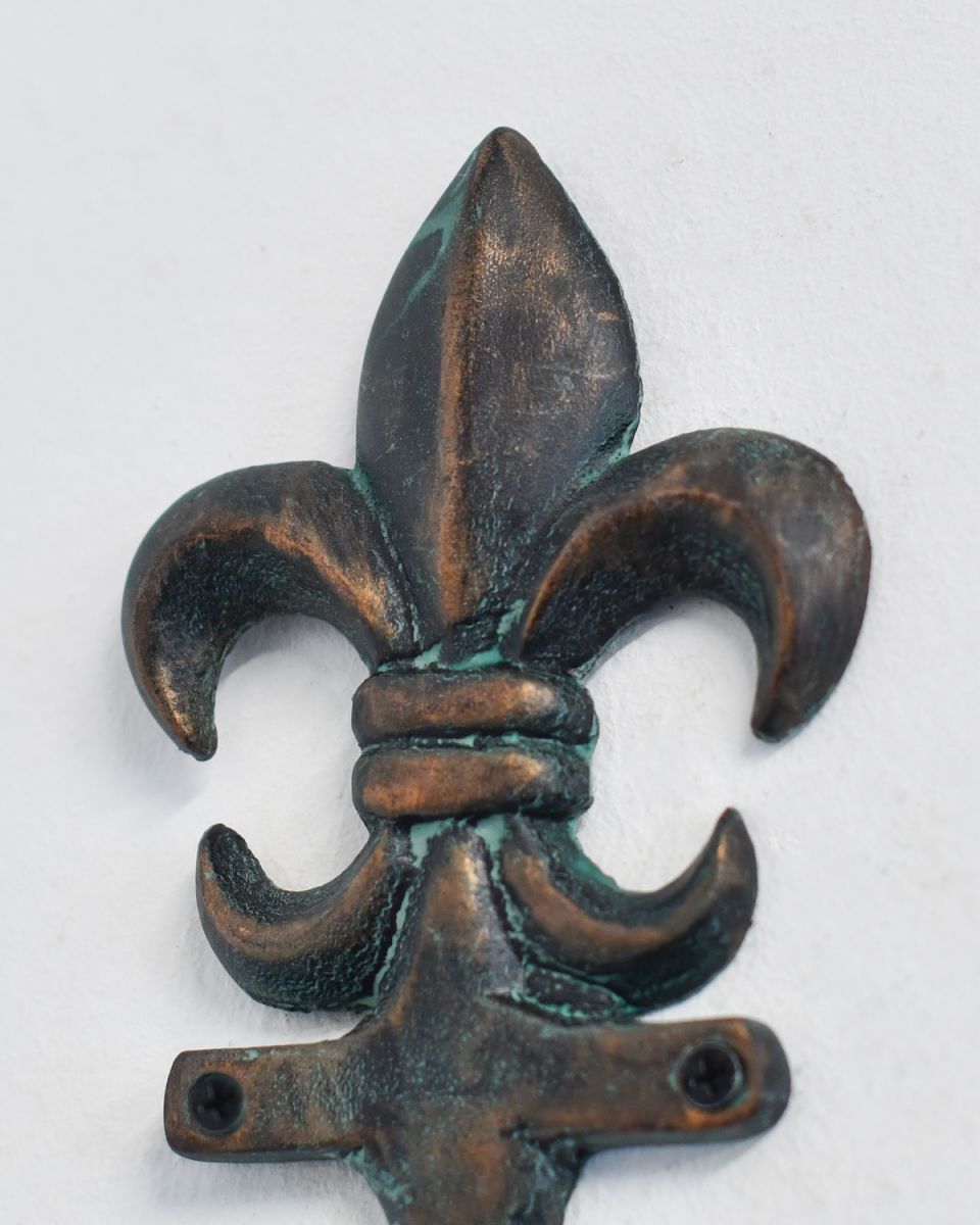 Close up of intricate verdigris detail on Fleur-De-Lis Hook