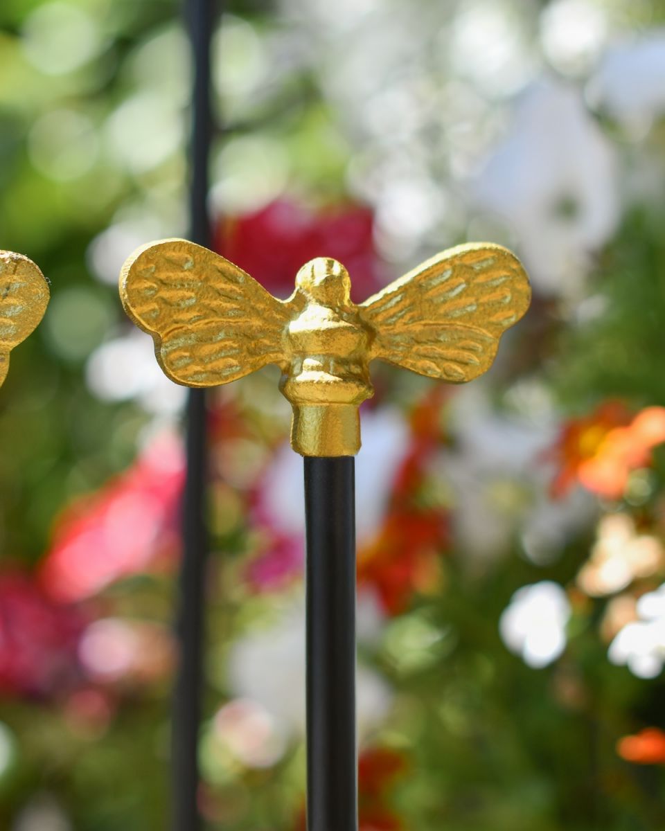 Close up of gold bumblebee detailing on welly rack