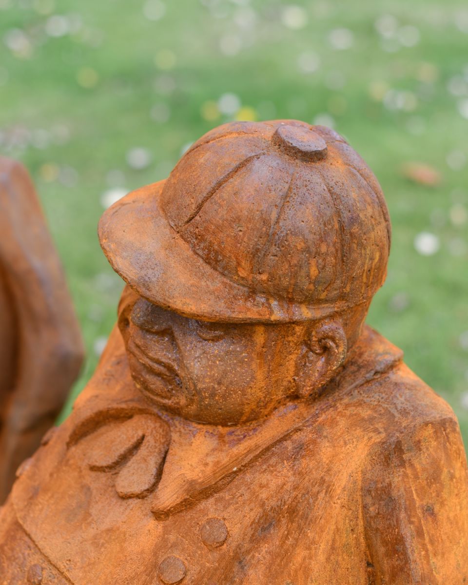 Close up of rustic hat detail on tweedledee and tweedledum patio statues