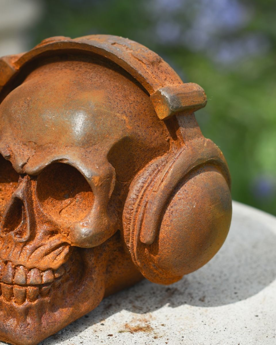 close up of headphone detail on cast iron garden skull ornament