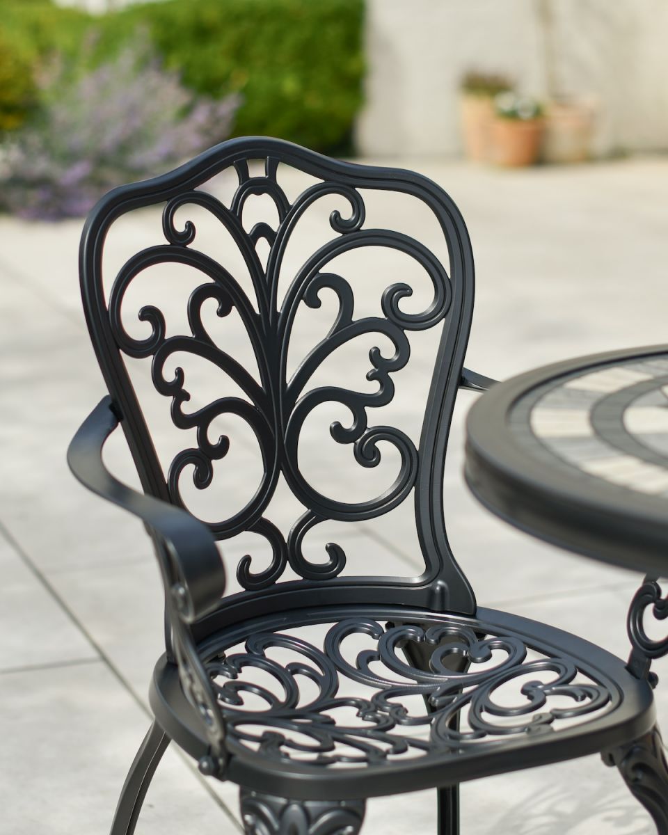 Close up of ornate chair backrest detail on two seater patio furniture set