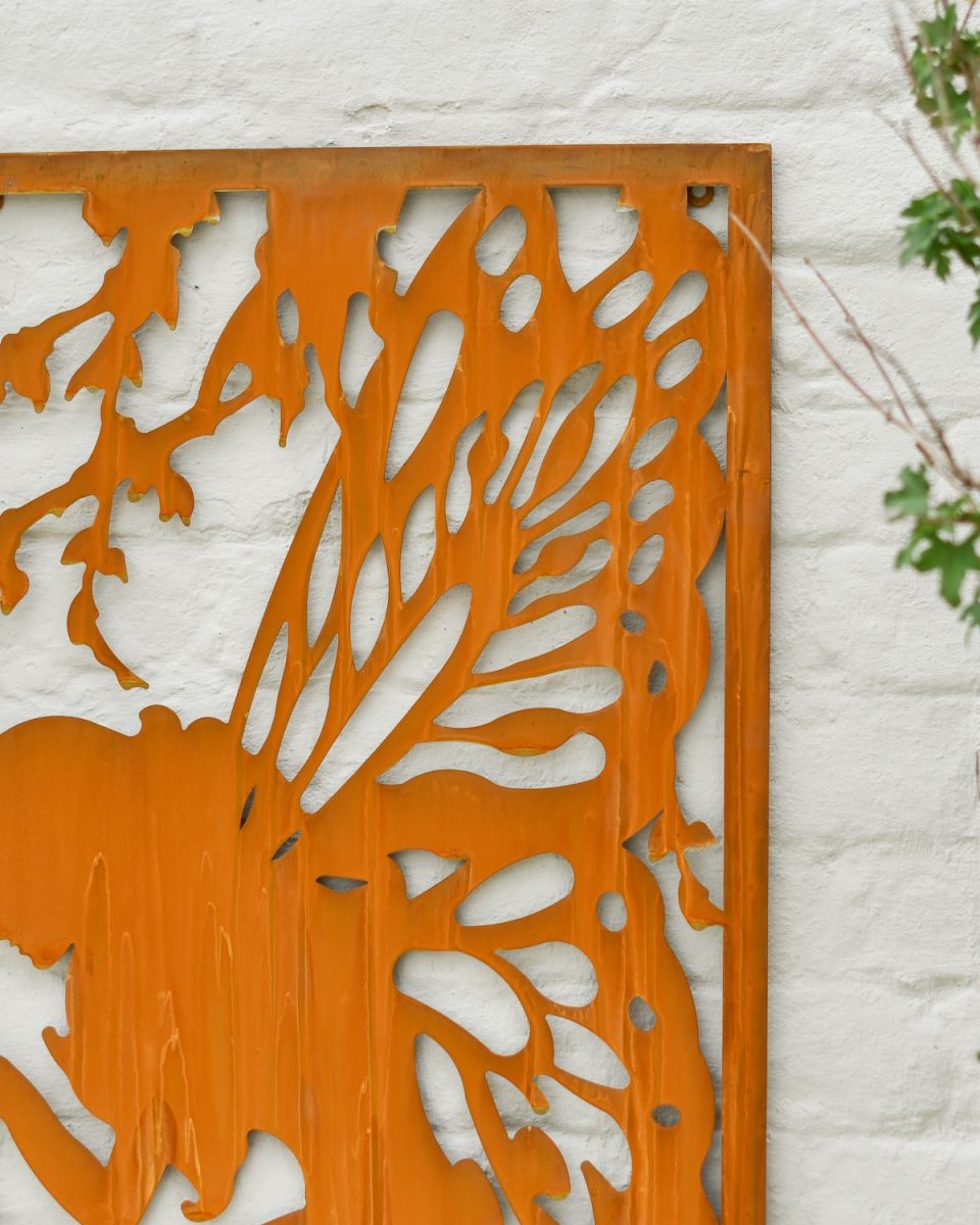 Close up of intricate cut out fairy detail on rustic garden wall art
