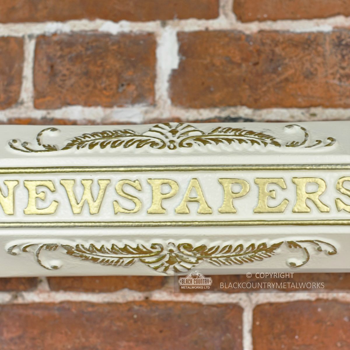 Close Up of Lettering on Cream Newspaper Holder