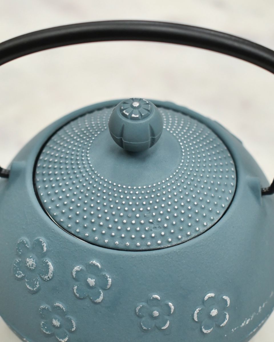 Close up of intricate detailing on lid and black handle detail on Blue & Silver Uwade Style Teapot with Floral Detailing