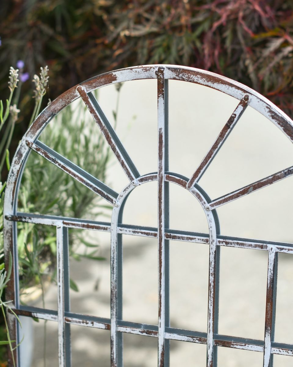 Close up of rustic finish on metal garden mirror