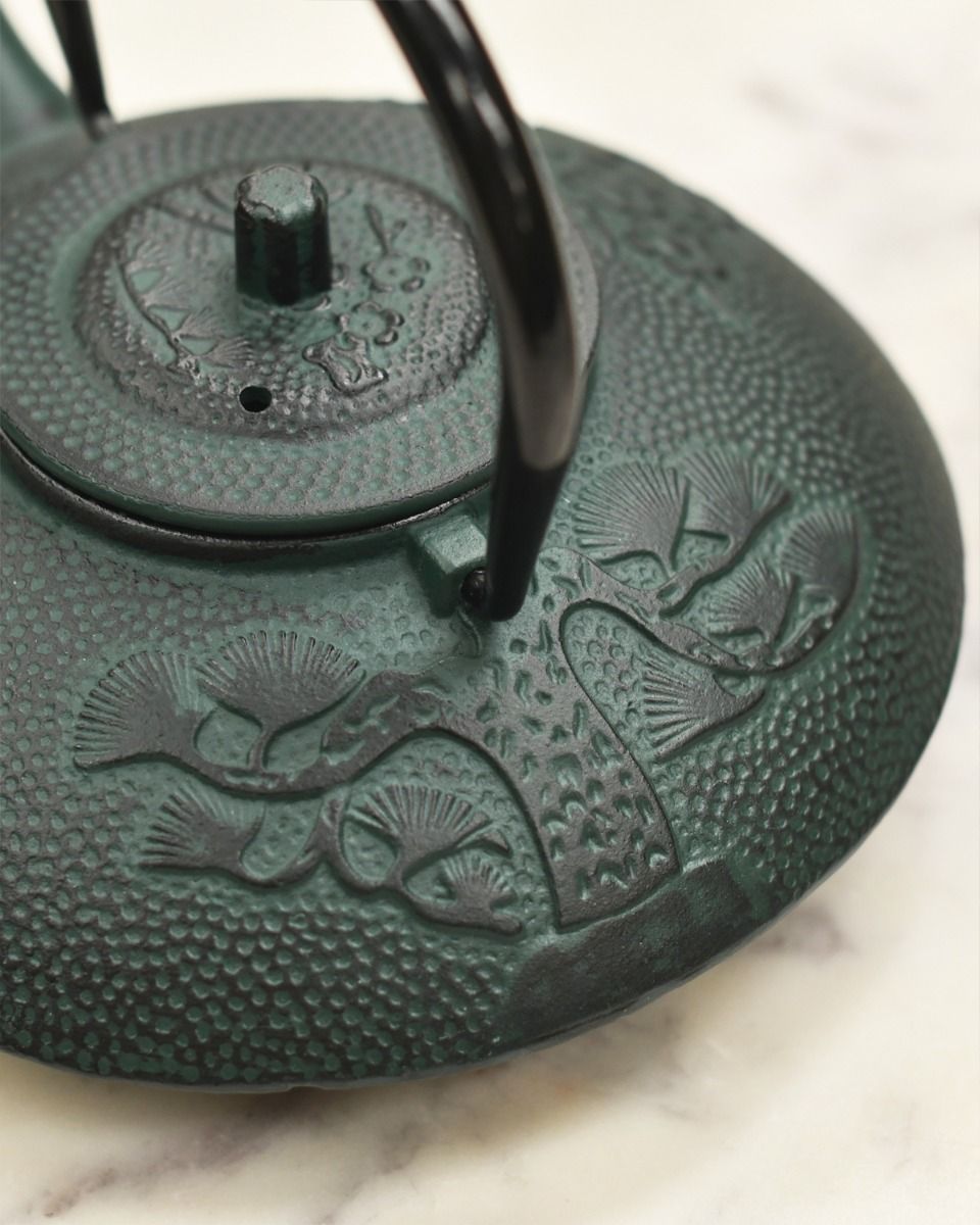 Black Handle Up on Dark Green Bamboo Design Teapot 